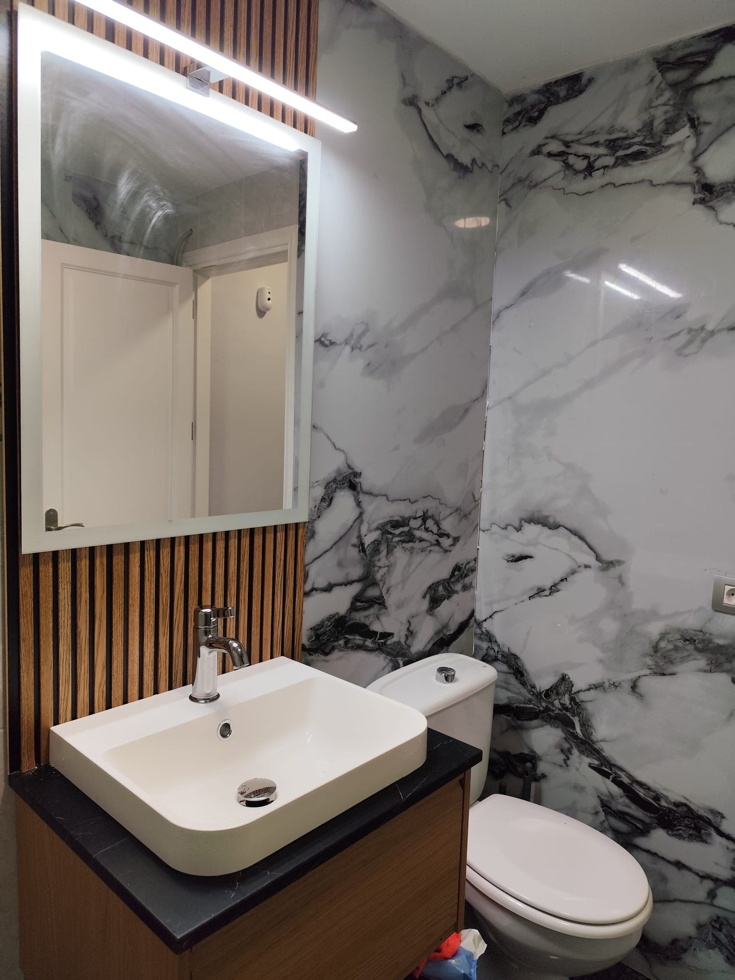 Onyx Flow feature wall in a luxury Tenerife home bar area, showcasing its dramatic veining.