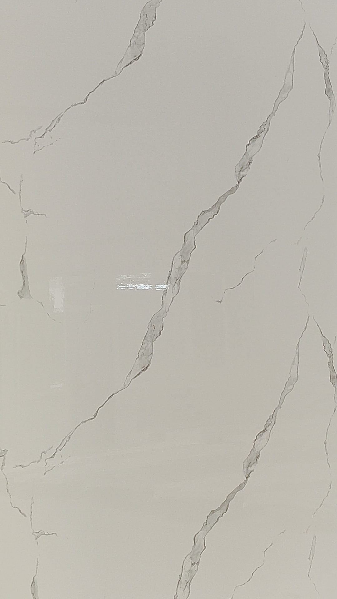Luxury Calacatta Grace gloss white wall panel with subtle grey veining in a Tenerife bathroom.