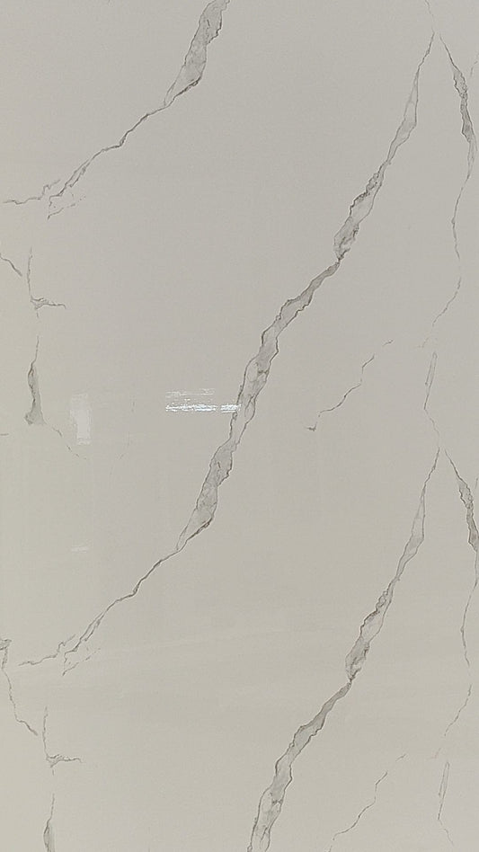 Luxury Calacatta Grace gloss white wall panel with subtle grey veining in a Tenerife bathroom.