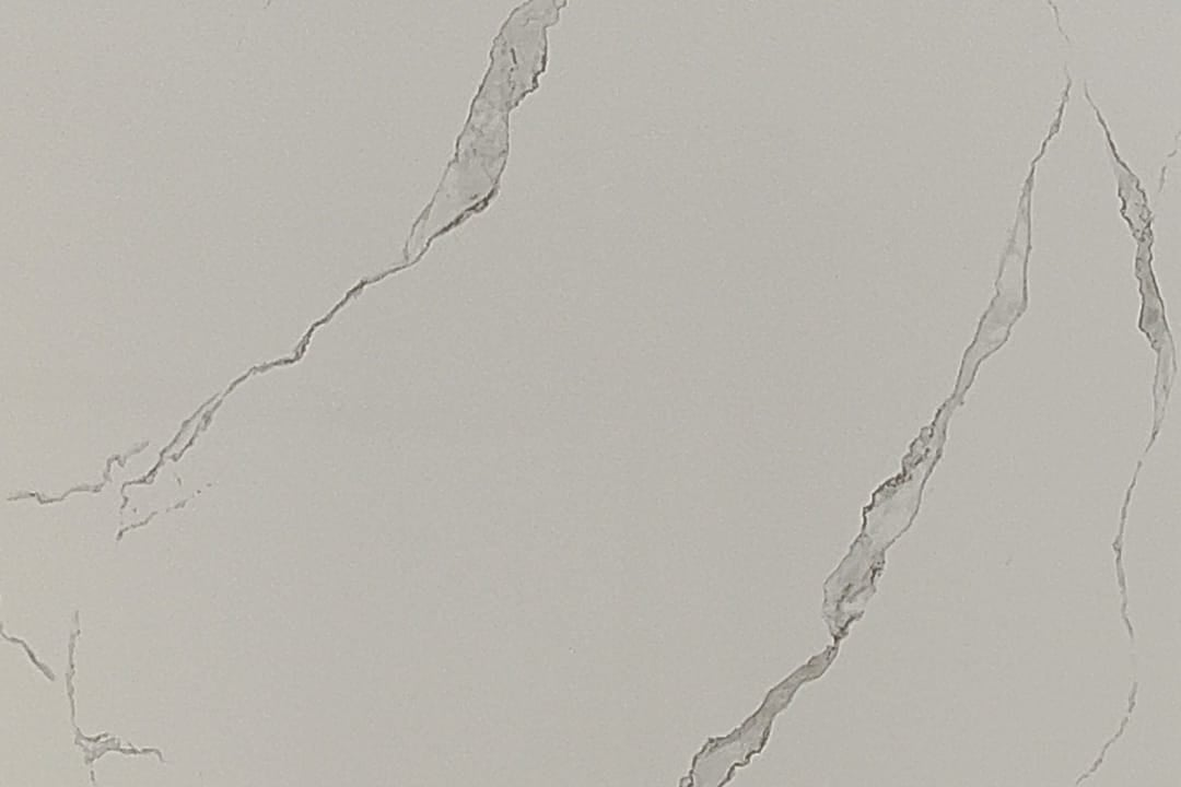 Close-up detail of the delicate grey veining on the bright white Calacatta Grace panel.