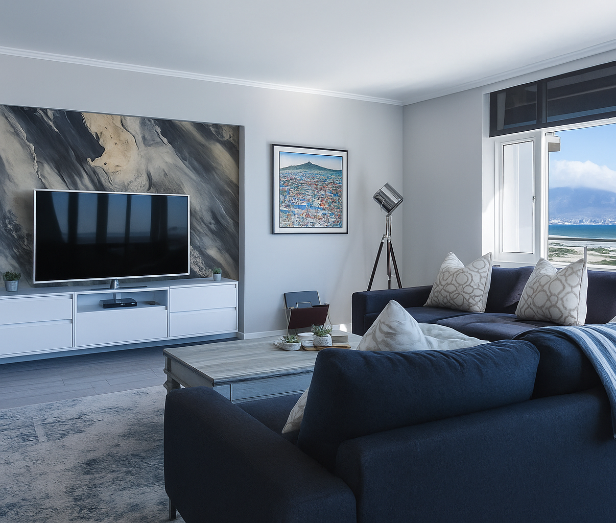 Modern living room with a large TV, sofa, and decorative items.